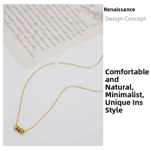 Close-up of golden titanium steel necklace with a finely textured cylindrical pendant