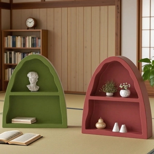Close-up of arched two-tier resin storage trays with matte texture in green and brick red