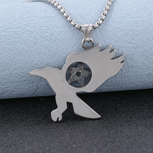 Polished stainless steel eagle wings and pentagram pendant necklace on a textured background