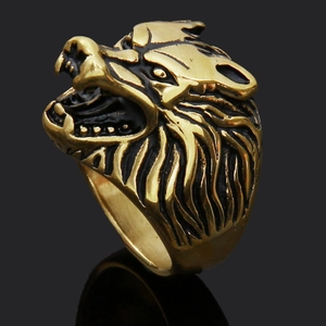Macro shot of gold-tone wolf head ring with intricate Nordic rune details and vintage finish
