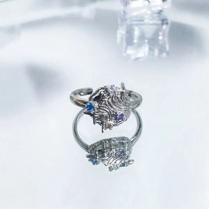 Detailed view of silver open ring featuring purple and blue zircon heart butterfly design