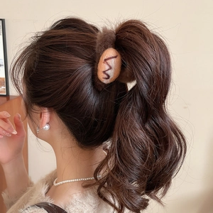 Detail of plush brown bread scrunchie showing faux fur texture and toast design