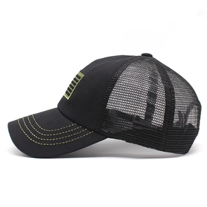 Detail of black trucker hat featuring green contrast stitching and breathable mesh panels