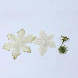 Detailed view of artificial Christmas flower parts with gold glitter and fabric petals