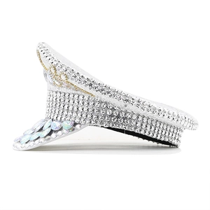 Detail of white captain hat with silver sequins and large pear-shaped crystal rhinestones