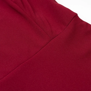Detailed close-up of red polyester fabric stitching and draped texture on long dress