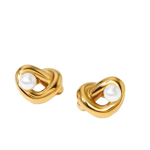 Polished gold twisted heart earrings with white faux pearl centers on white background