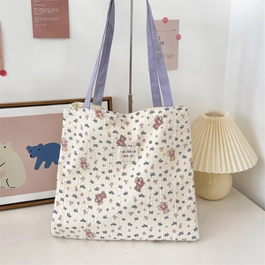 Close-up of the bubble texture canvas tote bag with purple floral and bear patterns