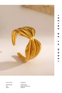 Detail of 18K gold plated open ring featuring a unique spiral wavy metal texture