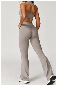 Rear view of high-waisted flared yoga pants and racerback top set in dusty purple
