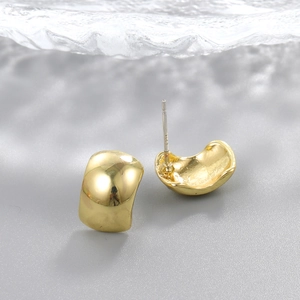 Macro view of gold teardrop earrings showing S925 sterling silver hallmark engraving