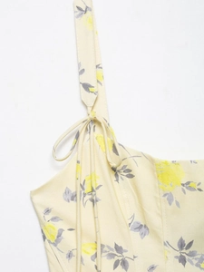 Detailed macro shot of yellow floral poplin dress with delicate self-tie shoulder straps