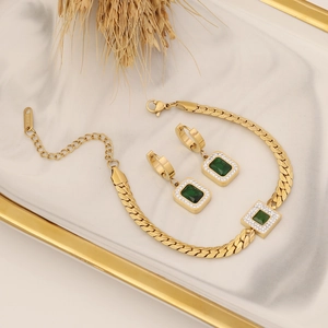 Stainless steel jewelry set with square emerald zircon on white marble tray