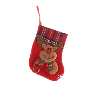 Classic red felt Christmas stocking with plaid reindeer applique on white background