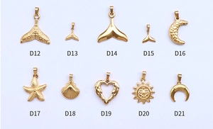 Detailed close-up of 10 gold moon and starfish charms in stainless steel with model labels