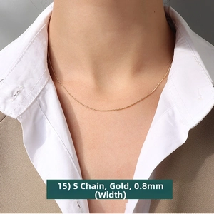 Close-up of a 0.8mm gold S-shaped chain necklace worn on neck with professional styling
