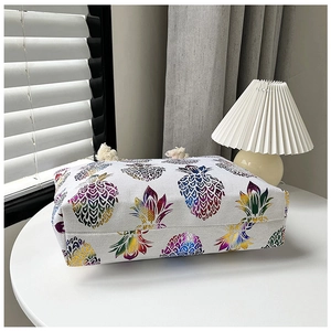 Detailed macro view of linen-style canvas tote bag with gradient pineapple print and tassel
