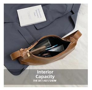 Interior view of brown hobo bag showing large capacity with phone and cosmetics
