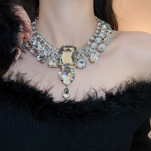 Detailed shot of large crystal heart and teardrop pendant on glamorous silver necklace
