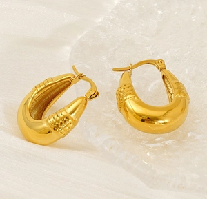 Detail shot of 18K gold plated U-shaped earrings with unique woven texture and polished finish