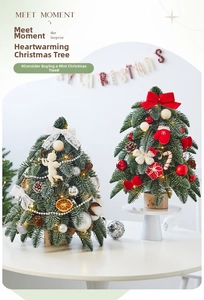 Close-up of mini Christmas trees with pine cones, dried oranges, and festive LED lights