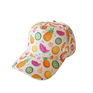 Detailed close-up of kids baseball cap with vibrant colorful fruit print on white fabric