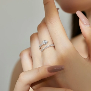Detail of S925 sterling silver ring with pear-shaped zircon and pavé setting on finger