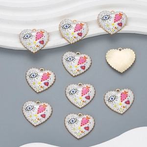 Macro detail of colorful heart charms with gold wavy borders for DIY jewelry making