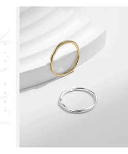 Detailed macro of S925 sterling silver stamp on minimalist irregular wavy rings