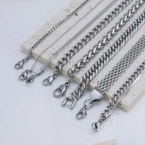 Silver stainless steel Cuban and snake chain bracelets with lobster clasps on stone