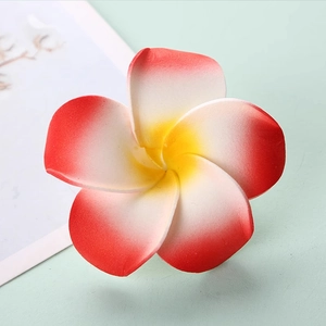 Macro shot of realistic red and white gradient EVA plumeria flower with yellow center