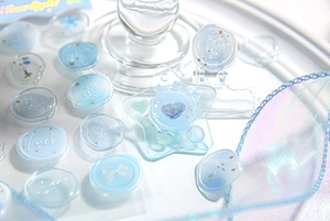 Macro shot of blue 3D resin wax seal stickers featuring For You and Luck engravings