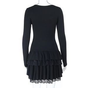 Detail of black mini dress featuring a triple-layered ruffle hem with delicate lace trim