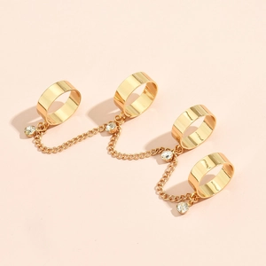 Detailed close-up of golden four-ring connected hand chain with five clear crystals
