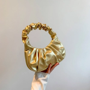 Chic golden metallic pleated dumpling cloud bag with elegant ruched handle for women