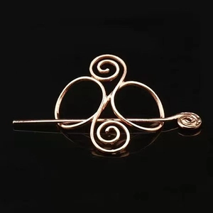 Detailed close-up of rose gold Celtic knot hair pin with vintage metallic finish