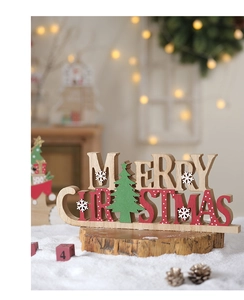 Detail of wooden Merry Christmas tabletop ornament with laser-cut trees and snowflake