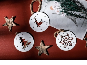 Detail of white metal reindeer and snowflake ornaments with rustic wooden star pendant