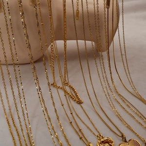 Vintage 18K gold plated stainless steel heart necklaces displayed on a model bust