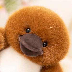 Close-up of soft plush platypus toy face with fluffy brown fur and realistic details