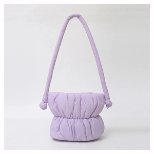 Detail of lavender puffer hobo bag showing quilted nylon texture and knot strap design