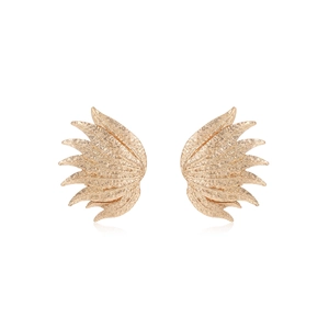 Close-up of golden flame-shaped earrings with textured hammered finish on white background