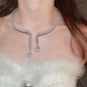 Detail shot of elegant silver teardrop zircon necklace with shimmering pavé diamonds