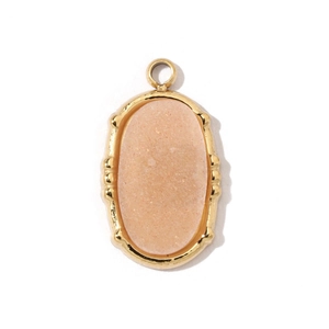 Close-up of an oval pendant featuring pink natural stone set in a gold-plated frame