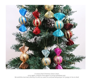 Close-up of glittery candy-shaped Christmas tree ornaments hanging on snowy branches