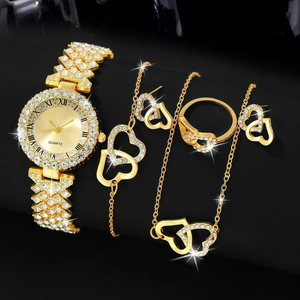 Golden watch and jewelry set with heart crystal accents on dark background