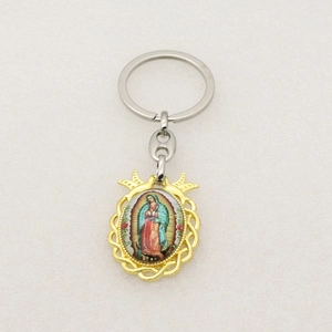 Detail of Our Lady of Guadalupe image on golden hollow metal keychain pendant