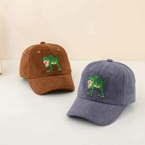 Close-up of corduroy texture and green dinosaur embroidery on vintage baseball caps