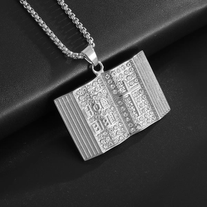 Close-up of Bible pendant with crystals and Holy Bible engraving on silver chain
