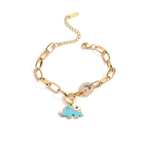 Detail of gold chain bracelet with blue enamel elephant and crystal ring pendants